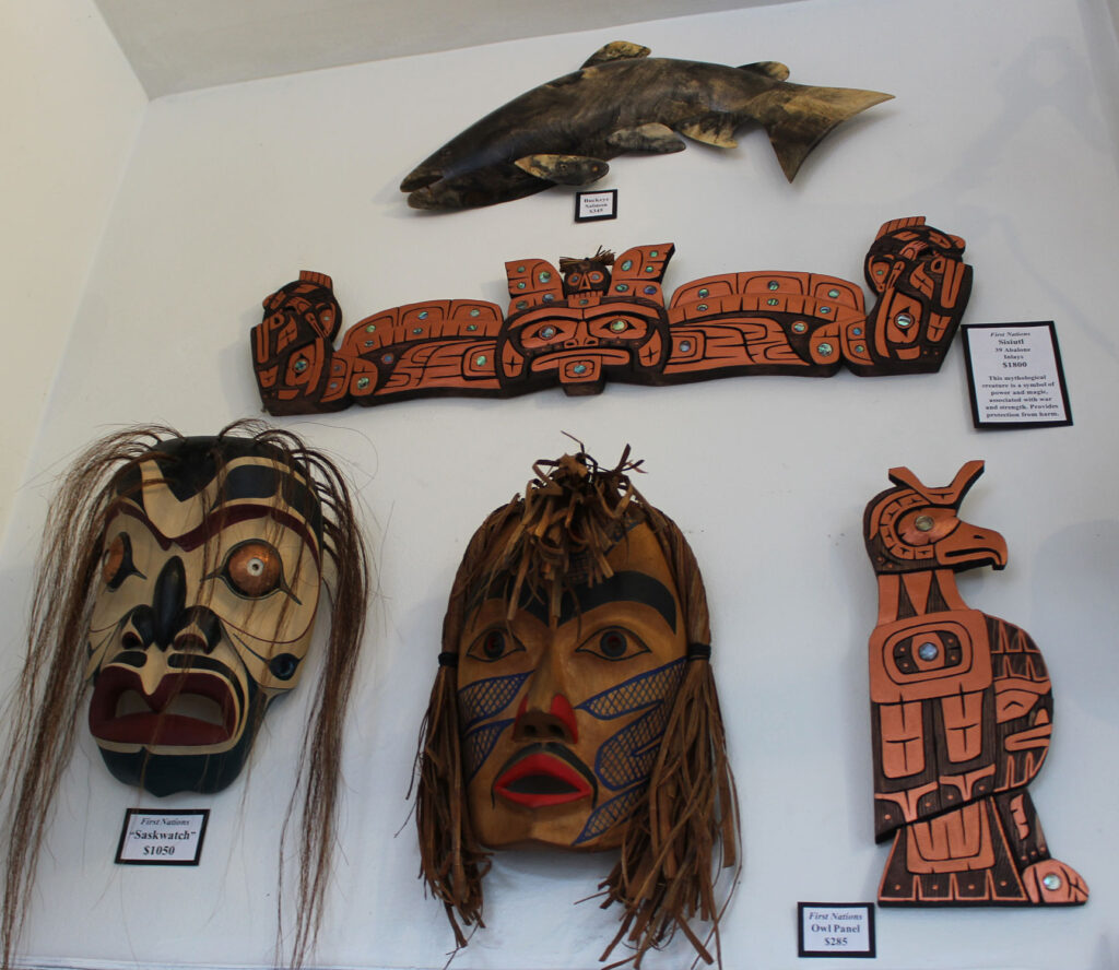 Masks and wall panels over entryway doors